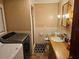 Bathroom with shower, toilet, vanity, and washer/dryer at 1006 39Th W Ave, Bradenton, FL 34205