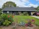 Cute ranch home with a well-manicured lawn and colorful flowers at 1006 39Th W Ave, Bradenton, FL 34205