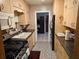 Efficient galley kitchen with wood cabinets and ample counter space at 1006 39Th W Ave, Bradenton, FL 34205