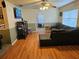 Living room featuring hardwood floors, sectional sofa, and large TV at 1006 39Th W Ave, Bradenton, FL 34205