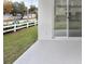 Covered back patio with view of backyard and kitchen at 2411 Orange Harvest Pl, Seffner, FL 33584