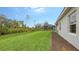 Landscaped backyard with grassy area and privacy hedge at 18265 Vizcaya Ct, Venice, FL 34293
