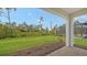 Spacious backyard with grassy lawn, paver patio, and screened pool at 18265 Vizcaya Ct, Venice, FL 34293
