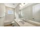 Clean bathroom with single vanity, tub, and tiled walls at 18265 Vizcaya Ct, Venice, FL 34293