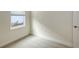 Well-lit bedroom with a window, carpet flooring, and neutral-toned walls at 18265 Vizcaya Ct, Venice, FL 34293