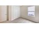 Bright bedroom with window, carpet flooring, and double door closet at 18265 Vizcaya Ct, Venice, FL 34293