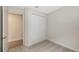 Bright bedroom with plush carpet, double door closet, and access to hallway at 18265 Vizcaya Ct, Venice, FL 34293