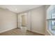 Light and airy bedroom with tile flooring and access to another room at 18265 Vizcaya Ct, Venice, FL 34293