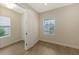 Bright bedroom with tile floors, window with blinds, and access to another room at 18265 Vizcaya Ct, Venice, FL 34293