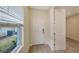 Bright entryway with white door and neutral-toned tile flooring at 18265 Vizcaya Ct, Venice, FL 34293
