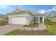 House exterior featuring a white garage door and landscaped walkway at 18265 Vizcaya Ct, Venice, FL 34293