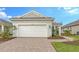 Single-story home with white garage door and paved driveway at 18265 Vizcaya Ct, Venice, FL 34293