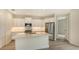 Modern kitchen with white cabinets, stainless steel appliances and an island at 18265 Vizcaya Ct, Venice, FL 34293