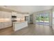 Bright kitchen featuring white cabinets, stainless steel appliances, and access to backyard at 18265 Vizcaya Ct, Venice, FL 34293