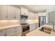 Modern kitchen with white cabinets, stainless steel appliances, and an island at 18265 Vizcaya Ct, Venice, FL 34293