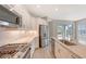 Modern kitchen with white cabinets, stainless steel appliances and an island at 18265 Vizcaya Ct, Venice, FL 34293