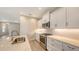 Modern kitchen with white cabinets, stainless steel appliances, and an island at 18265 Vizcaya Ct, Venice, FL 34293