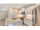 Modern kitchen with white cabinets, stainless steel appliances and an island at 18265 Vizcaya Ct, Venice, FL 34293