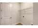 Convenient laundry room with overhead shelving and tile flooring at 18265 Vizcaya Ct, Venice, FL 34293