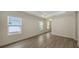 Open living area with large windows and neutral-toned tile floors at 18265 Vizcaya Ct, Venice, FL 34293