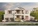 Two-story white farmhouse with a two-car garage and landscaping at 567 Luzon Ave, Tampa, FL 33606
