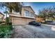 Townhouse exterior with two-car garage and a car parked in the driveway at 7001 Interbay Blvd # 336, Tampa, FL 33616