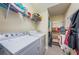 Convenient laundry room with washer, dryer, and shelving at 7001 Interbay Blvd # 336, Tampa, FL 33616