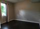 Well-lit bedroom with dark hardwood floors and window coverings at 9330 Hampshire Park Dr, Tampa, FL 33647