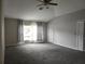 Spacious bedroom with carpet, large windows and ceiling fan at 9330 Hampshire Park Dr, Tampa, FL 33647