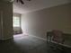 Bedroom with window, carpet, and a desk area at 9330 Hampshire Park Dr, Tampa, FL 33647