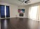 Bright living room with fireplace, hardwood floors, and large windows at 9330 Hampshire Park Dr, Tampa, FL 33647