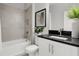 Modern bathroom with white vanity and dark countertop at 1937 W Arch St, Tampa, FL 33607