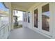 Covered back porch with white railings, offering a peaceful outdoor space at 1939 W Arch St, Tampa, FL 33607