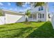 Home's backyard showcasing a large lawn and two-story house at 1939 W Arch St, Tampa, FL 33607
