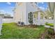 Landscaped backyard with a two-story house and AC units at 1939 W Arch St, Tampa, FL 33607