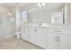 Clean bathroom with white cabinets, quartz countertop, and a walk-in shower at 1939 W Arch St, Tampa, FL 33607
