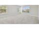 Bright bedroom with neutral carpeting and two windows at 1939 W Arch St, Tampa, FL 33607
