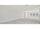 Spacious bonus room with neutral carpet and multiple windows, offering versatility at 1939 W Arch St, Tampa, FL 33607
