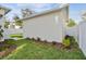 Detached garage with a white exterior and landscaping at 1939 W Arch St, Tampa, FL 33607