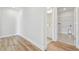 Light and bright hallway with hardwood floors and access to laundry and bath at 1939 W Arch St, Tampa, FL 33607