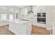 Modern kitchen with island, white cabinets and stainless steel appliances at 1939 W Arch St, Tampa, FL 33607