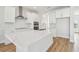 Island kitchen with white cabinets and quartz countertops at 1939 W Arch St, Tampa, FL 33607
