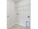 Laundry room with shelving and built-in dog door at 1939 W Arch St, Tampa, FL 33607