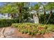 WynGate community entrance with lush landscaping and vibrant flowerbeds at 528 Black Lion Ne Dr, St Petersburg, FL 33716