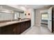 Double vanity bathroom with dark brown cabinets and granite countertops at 288 Rain Berry Ave, Ruskin, FL 33570