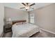 Bedroom with king-size bed, nightstand and ceiling fan at 288 Rain Berry Ave, Ruskin, FL 33570