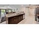 Kitchen island with granite countertop, double sink, and seating at 288 Rain Berry Ave, Ruskin, FL 33570