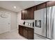 Laundry room with dark brown cabinets and stainless steel appliances at 288 Rain Berry Ave, Ruskin, FL 33570