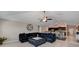 Spacious living room with a large sectional sofa and a ceiling fan at 288 Rain Berry Ave, Ruskin, FL 33570