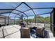 Relaxing screened patio with seating area and grill, perfect for outdoor entertaining at 288 Rain Berry Ave, Ruskin, FL 33570